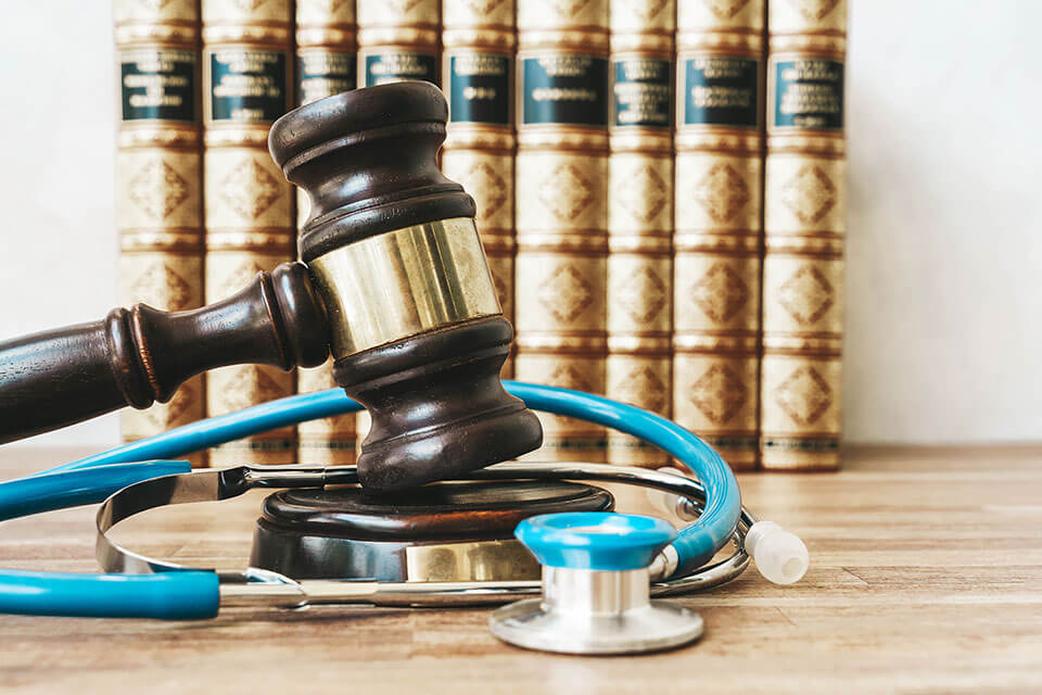 a gavel on a desk and a medical scope