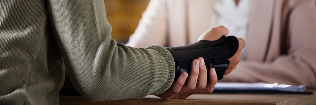 a person with a brace on their arm consulting with an attorney and asking what is a personal injury claim