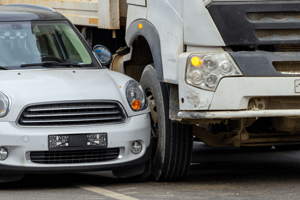 Car being sideswiped by truck on road 