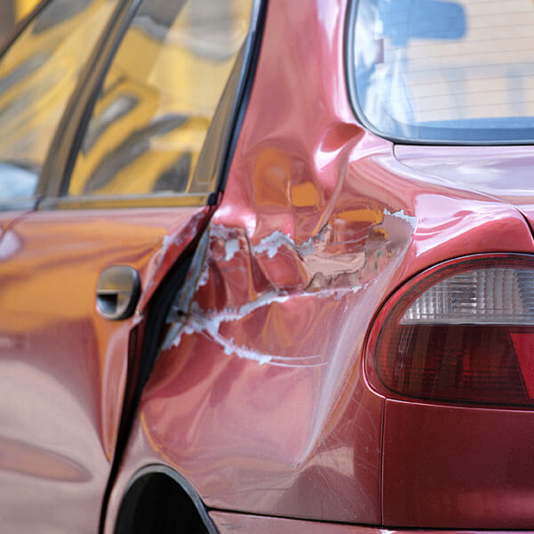 owner of red car with dent from accident needs an Auto Accident Attorney Kansas City 