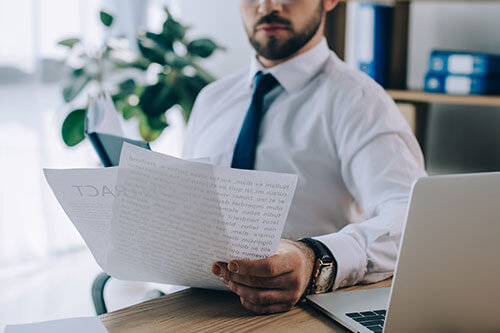 lawyer reading documents preparing for discovery in personal injury case