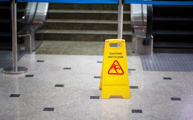 sign warning of slip and fall injury potential in public building